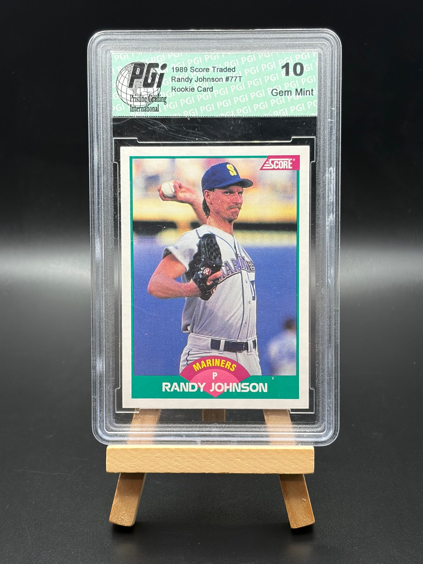 Baseball trading card of Randy Johnson in a protective case on a black background