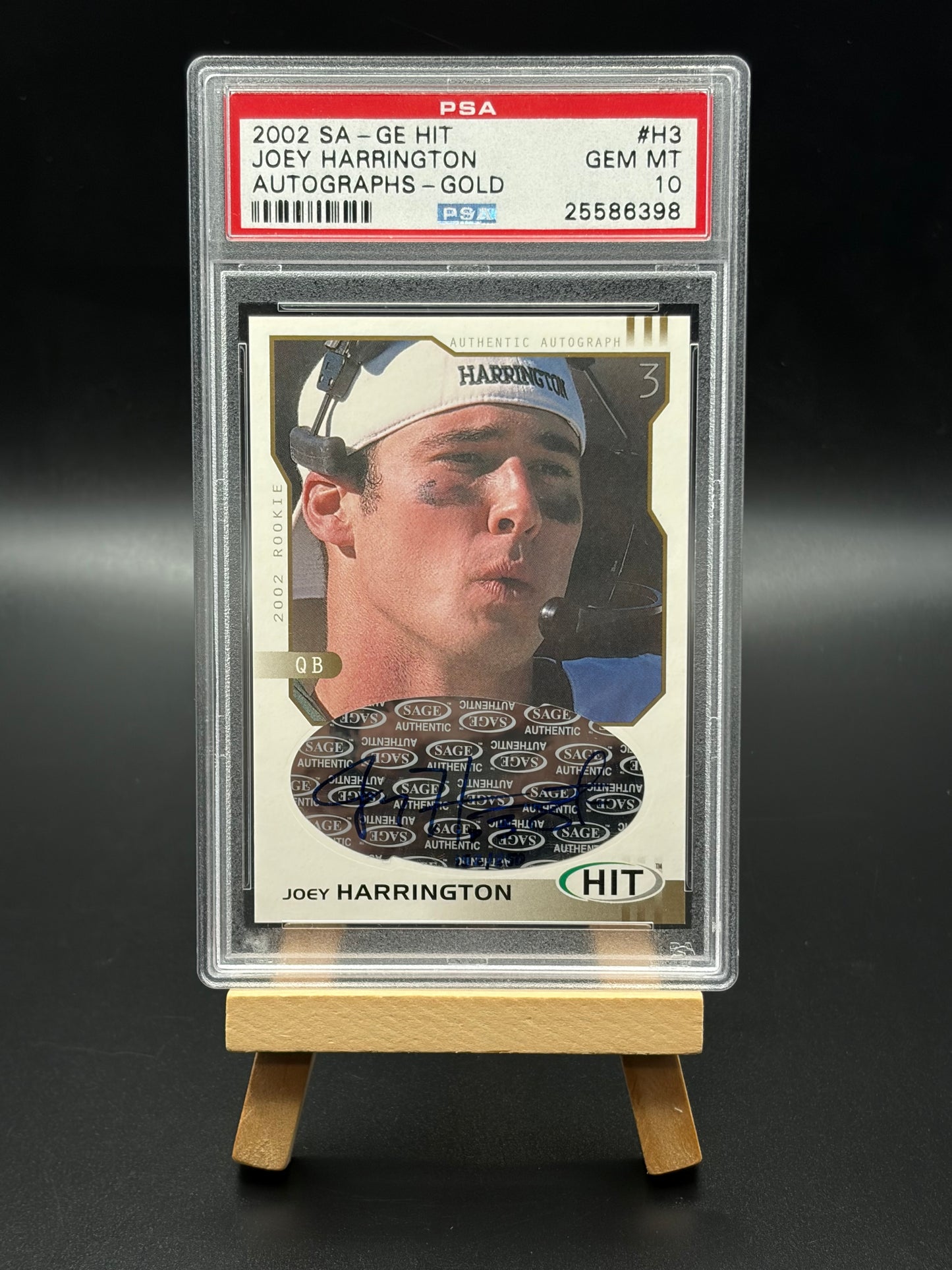 Trading card of Joey Harrington in a protective case on a dark background