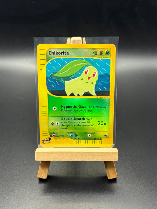 Chikorita trading card in a clear protective sleeve on a black background